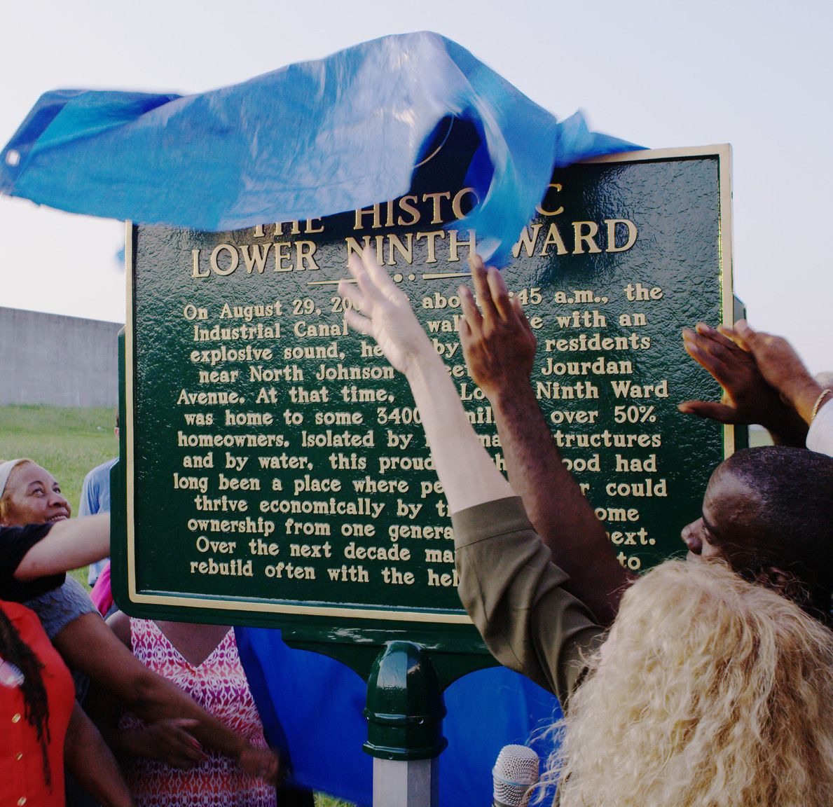Residents unveil the historic plaque at the Industrial Canal breach site in the Lower Ninth Ward